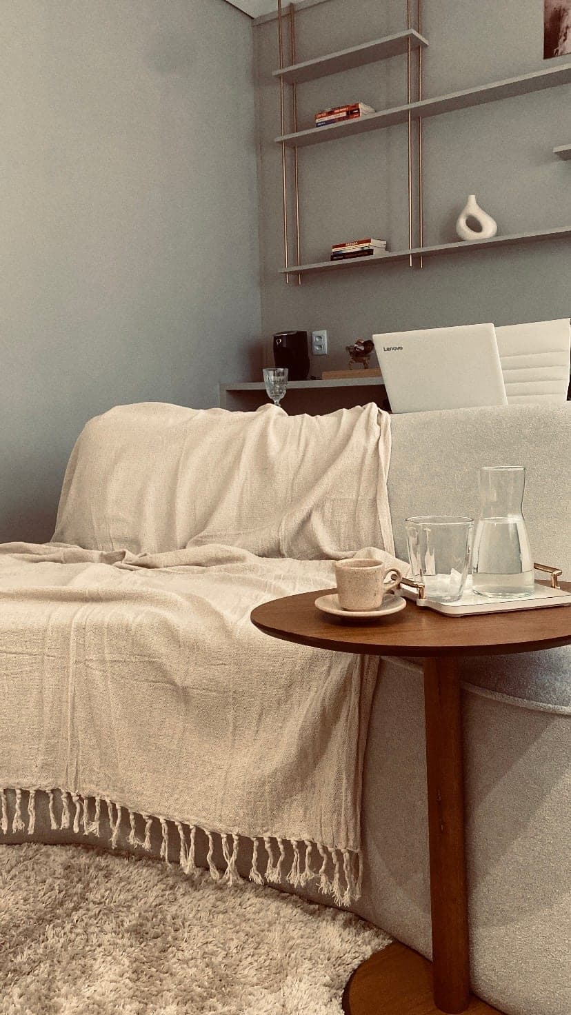 Sofá e mesinha com água e café no consultório